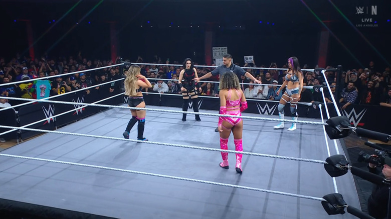 The four women inside the ring staring each other down