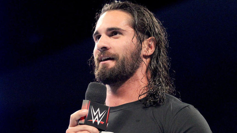 Seth Rollins smiling with a microphone