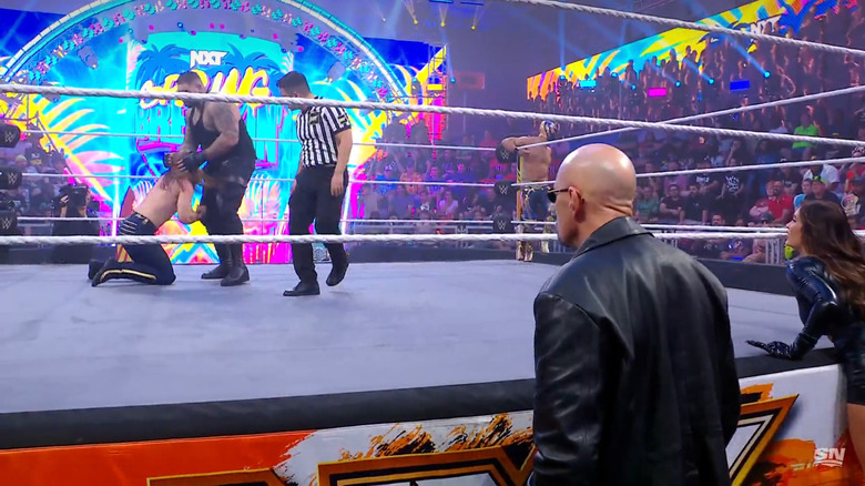 Rezar and Frazer in the ring as Paul Ellering and Scarlett watch on