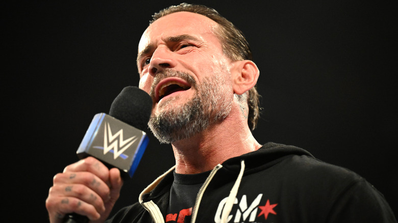 CM Punk speaking into a microphone