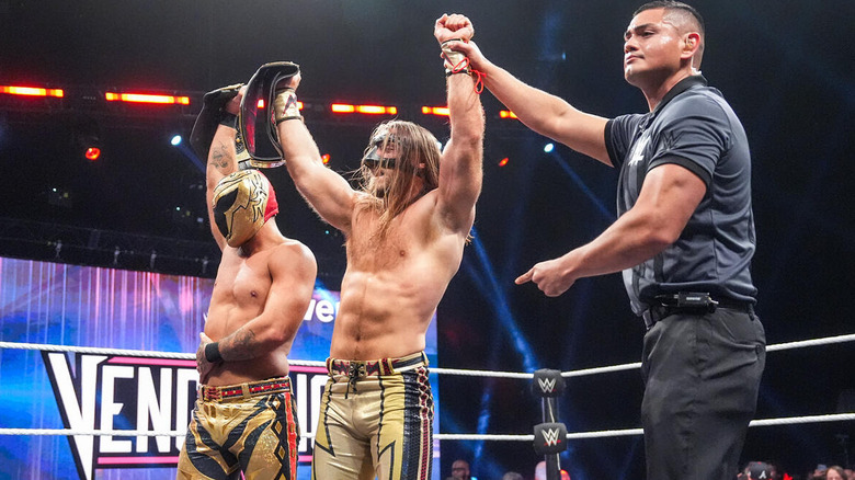 Referee raising the arm of Nathan Frazer and Axiom at WWE NXT Vengeance Day