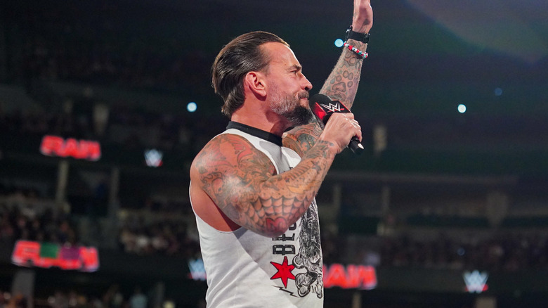 CM Punk raises his hand