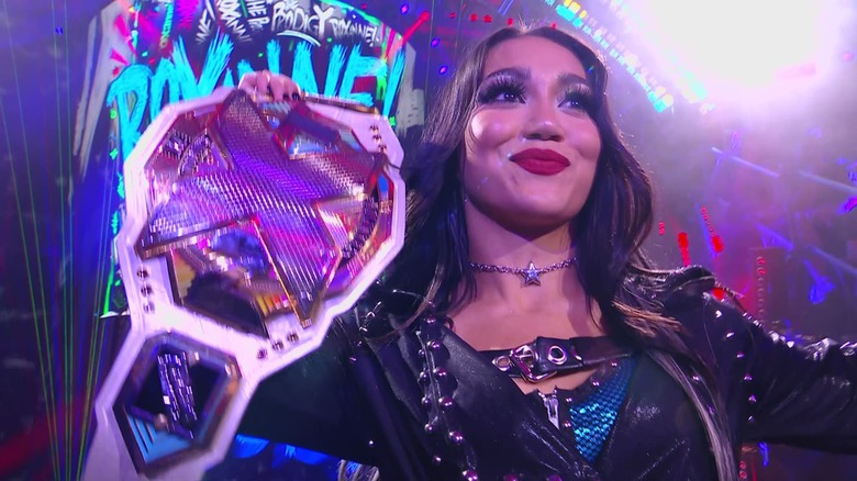 Roxanne Perez posing with the title