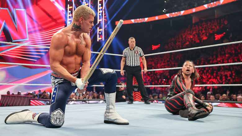 Cody Rhodes brandishes a kendo stick at Shinsuke Nakamura