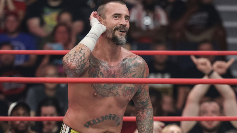 CM Punk puts a hand to his ear