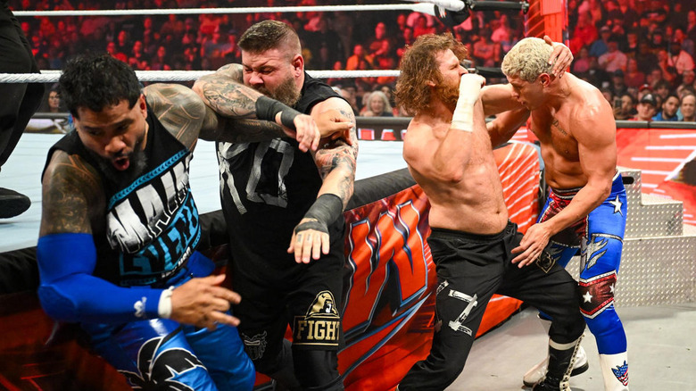 Jey Uso, Kevin Owens, Sami Zayn, and Cody Rhodes brawl outside the ring