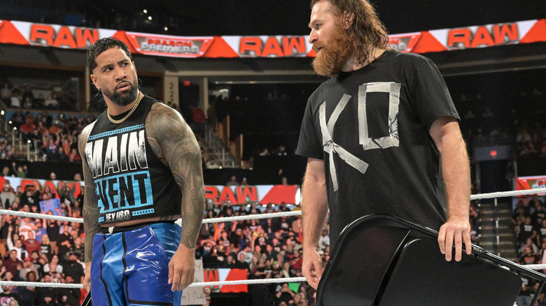 Jey Uso and Sami Zayn holding chairs