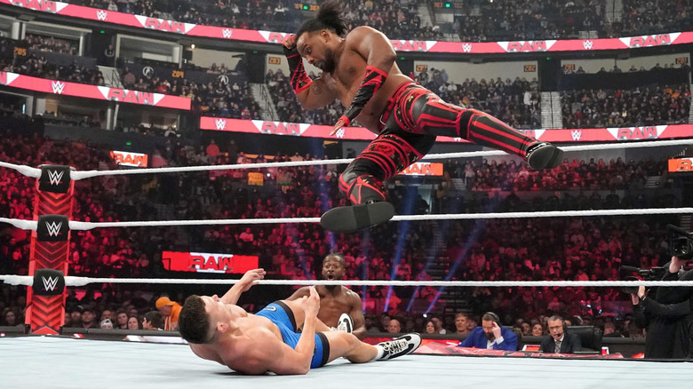 Xavier Woods dropping an elbow on Julius Creed