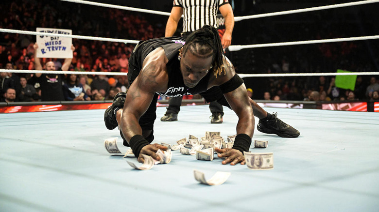 R-Truth picks up all the money he dropped