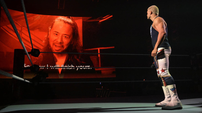 Cody Rhodes looking at Shinsuke Nakamura on a screen