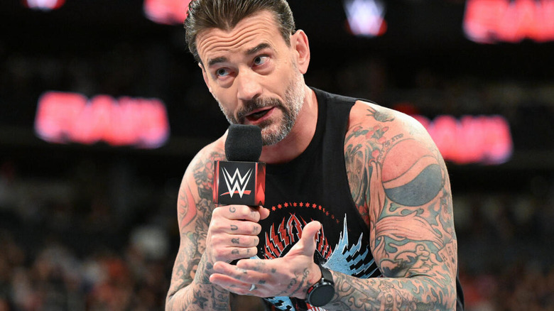 CM Punk talks into microphone on "WWE Raw"