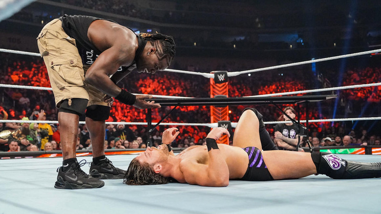 R-Truth waves his hand between his face and JD McDonagh