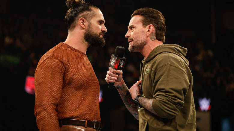 Seth Rollins and CM Punk face off with a microphone on "WWE Raw."