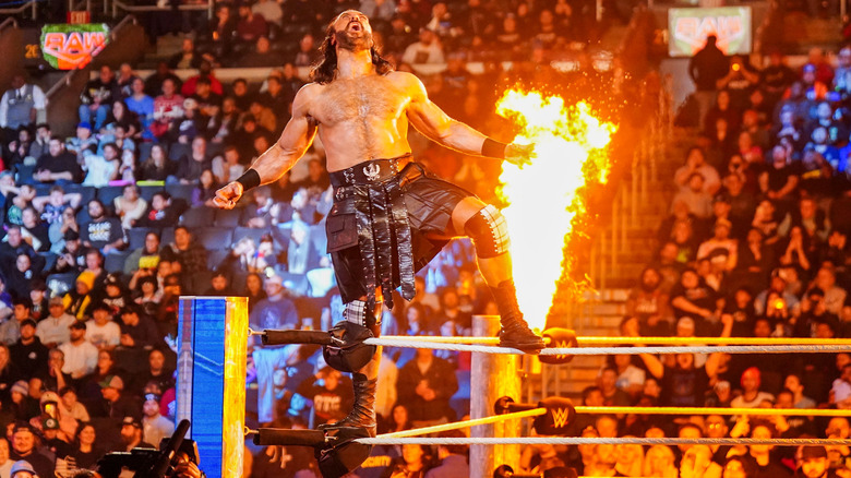 Drew McIntyre poses on the top rope while pyro goes off around him on "WWE Raw."