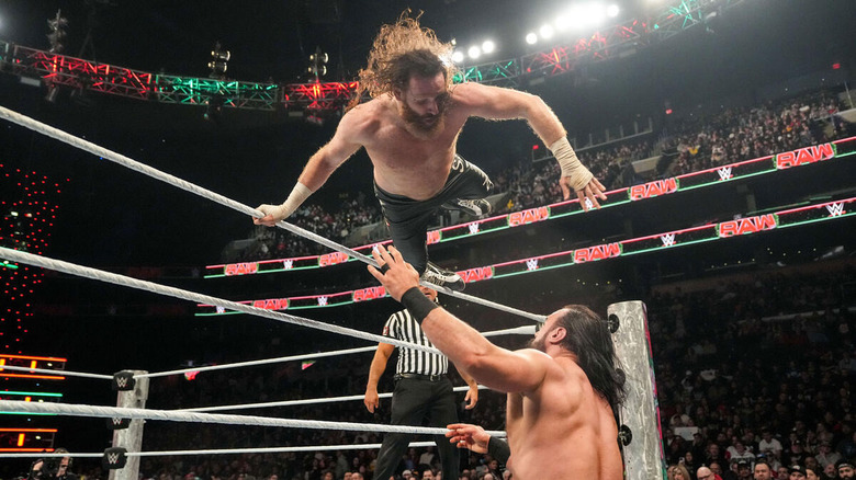 Sami Zayn leaps over the top rope onto Drew McIntyre on the outside on "WWE Raw."