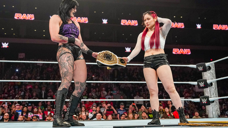 Rhea Ripley and IYO SKY both holding the Women's World Championship belt in the ring on "WWE Raw."