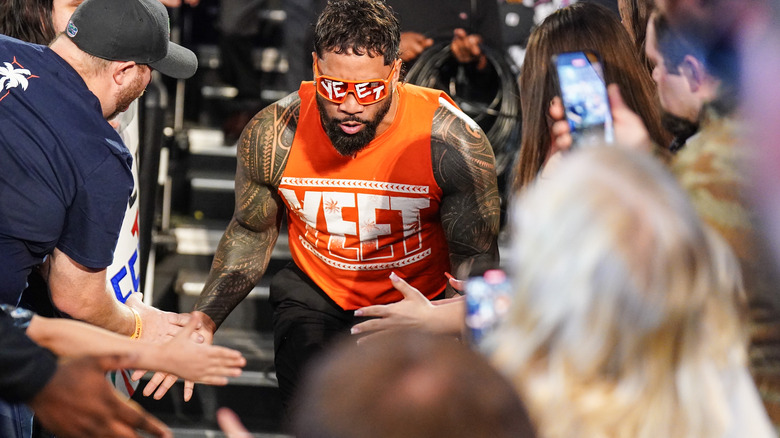 Jey Uso makes his entrance and slaps hands with fans on "WWE Raw"