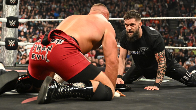 Bron Breakker and FInn Balor stare each other down on hands and knees in the ring on "WWE Raw"