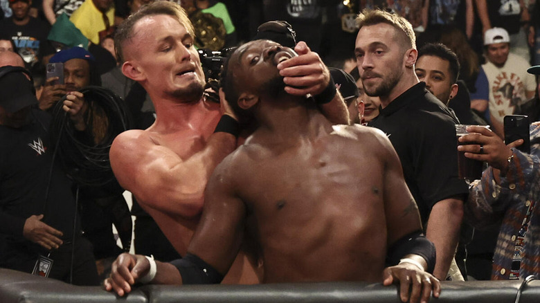 Ludwig Kaiser wrenching the neck of Kofi Kingston