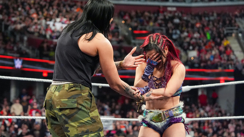 IYO SKY puts her face in her hand as Rhea Ripley tries to comfort her on "WWE Raw."