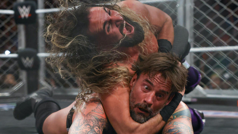 Seth Rollins screams as he applies an STF to CM Punk in the cage match main event of "WWE Raw."