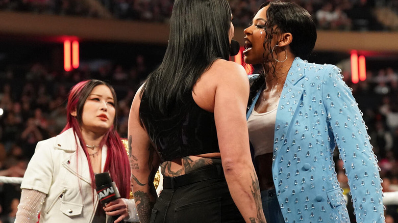 Bianca Belair yells at Rhea Ripley while IYO SKY watches beside them on "WWE Raw"