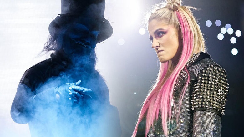 Uncle Howdy looms large over Alexa Bliss.
