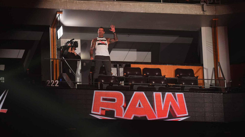 CM Punk stands and waves