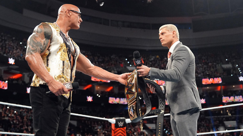 The Rock and Cody Rhodes trade belts