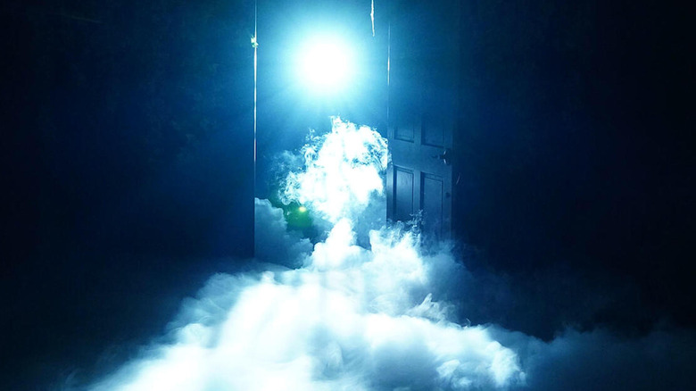 Open door with mist coming out lit by blue light
