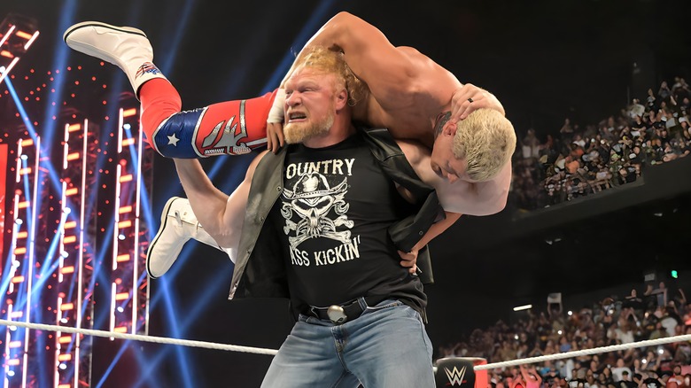 Brock Lesnar with Cody Rhodes on his shoulders