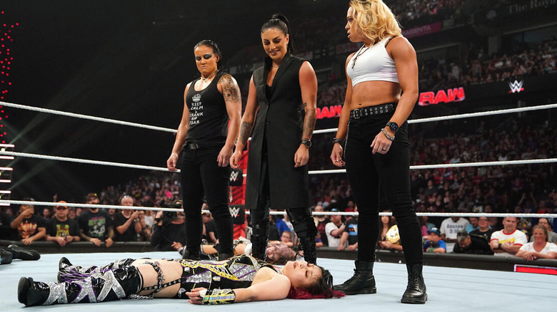 Shayna Baszler, Sonya Deville, and Zoey Stark standing over Damage CTRL