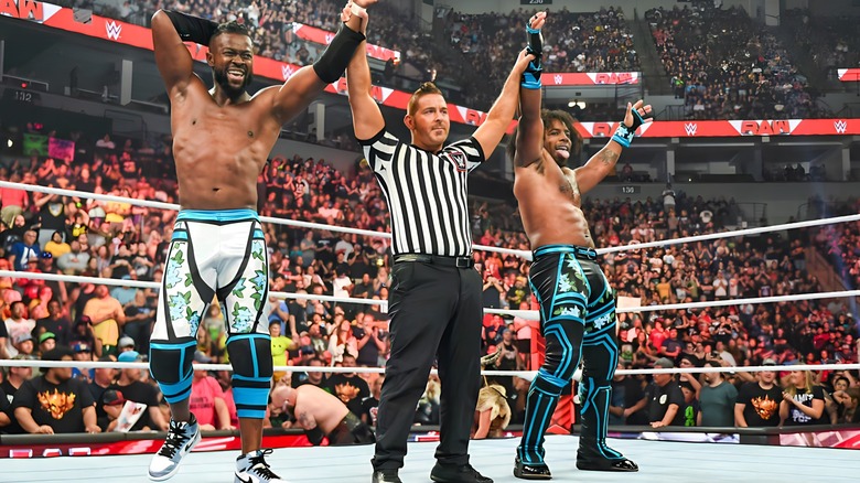 Kofi Kingston and Xavier Woods get their hands raised