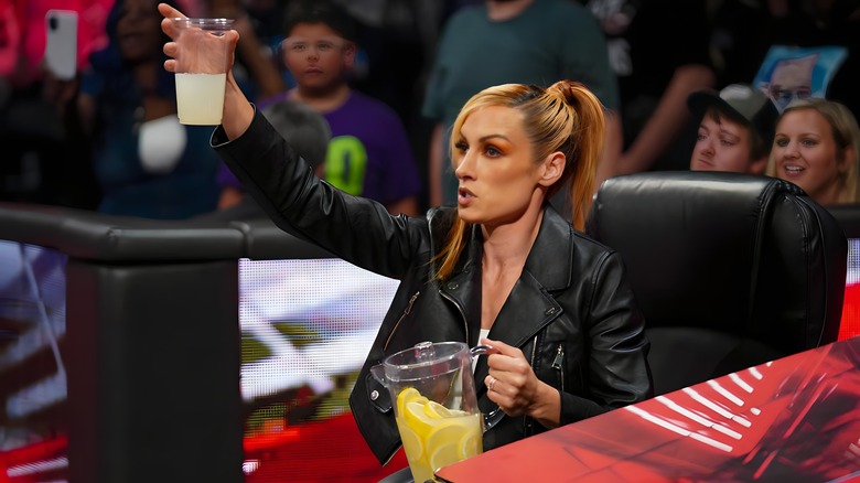 Becky Lynch holds up cup of lemonade