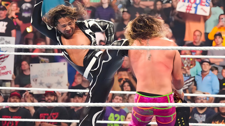 Shinsuke Nakamura kneeing Seth Rollins