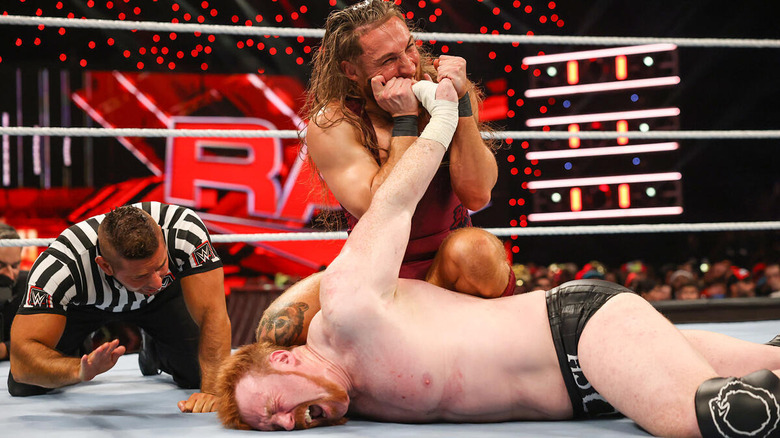 Pete Dunne biting Sheamus' hand