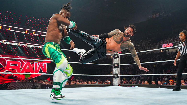 Jey Uso kicking Kofi Kingston