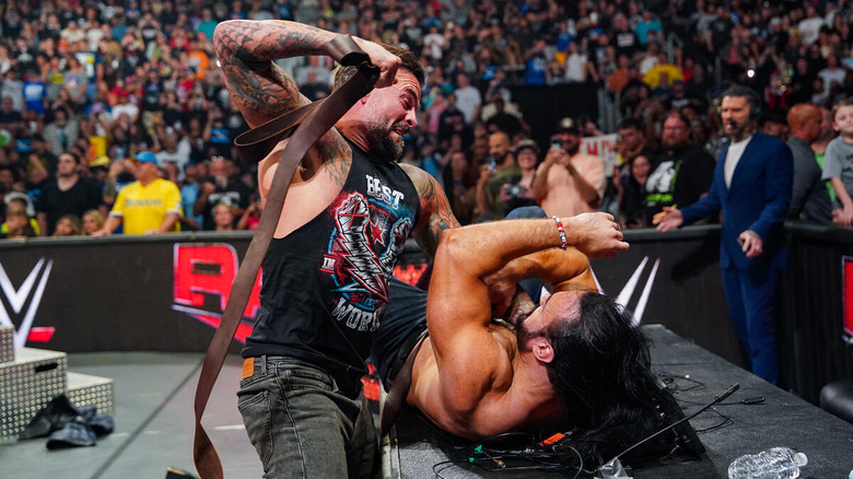 CM Punk punching Drew McIntyre