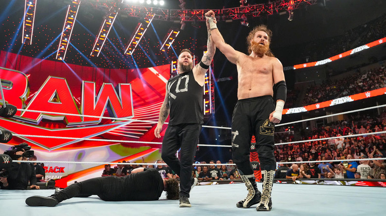 Kevin Owens raises Sami Zayn's arm