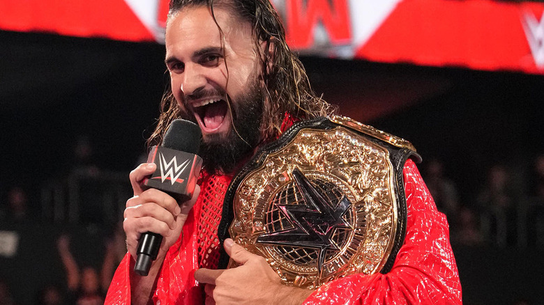 Seth Rollins win microphone and championship