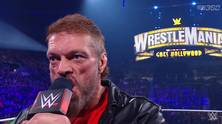 Edge with the WrestleMania sign behind him