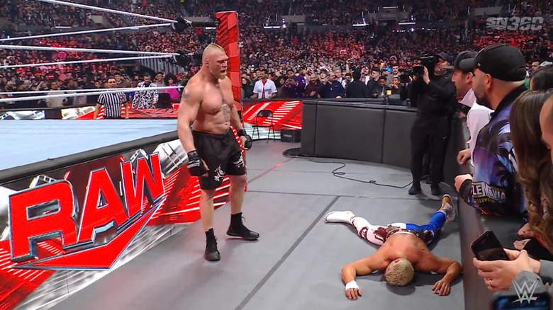 Lesnar standing over Rhodes