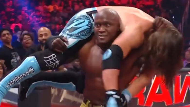 Lashley with Styles on his shoulders