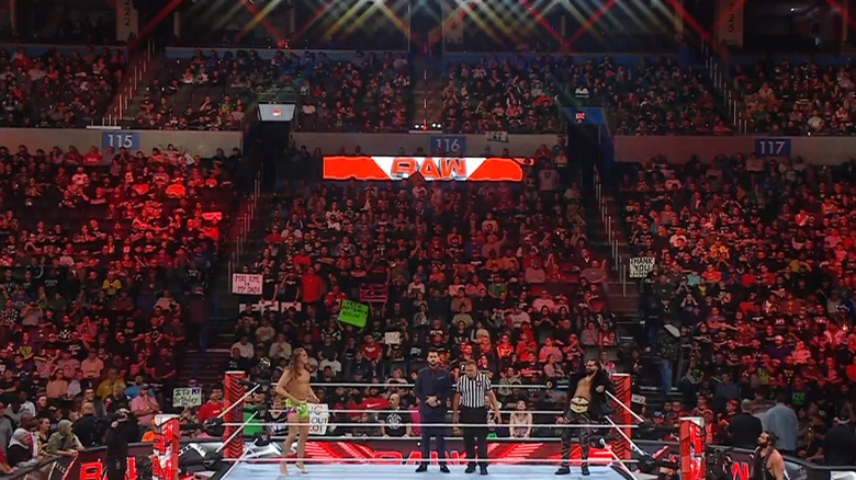 Riddle and Rollins facing off in the ring