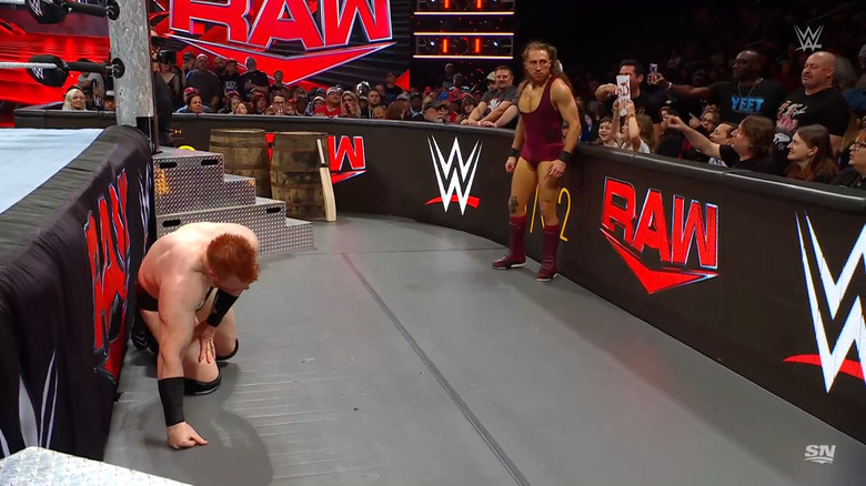 Sheamus and Dunne on the outside of the ring