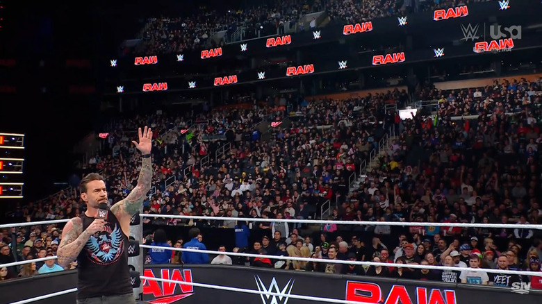 Punk in the ring raising his hand