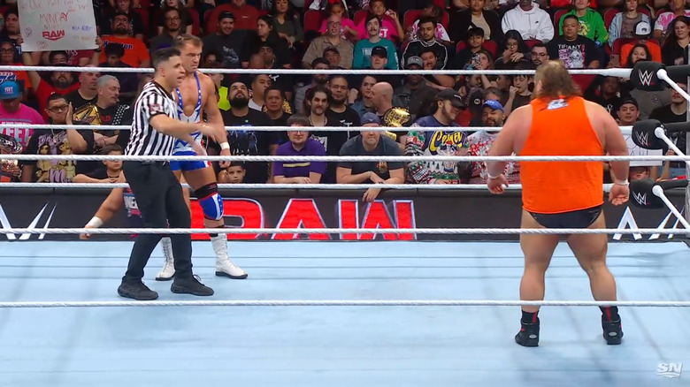 Gable and Otis in the ring staring each other down