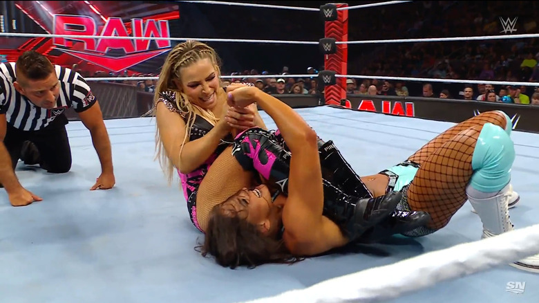 Natalya with James in an arm submission