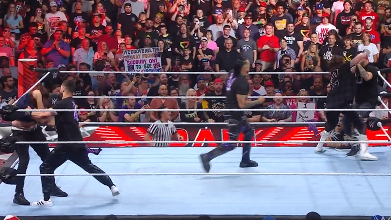 Judgment Day, Rollins, Owens, and Zayn in the ring