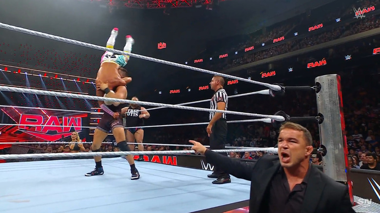 Julius landing a delayed vertical suplex on Tozawa as Gable hypes him up from the outside